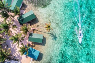 Tobacco Caye aerial in Belize barrier reef with boat