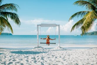 woman on a swing chair on a beach in cambodia