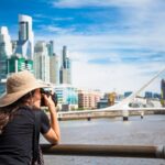 woman takes a photo of the puerto madero district of buenos aires argentina