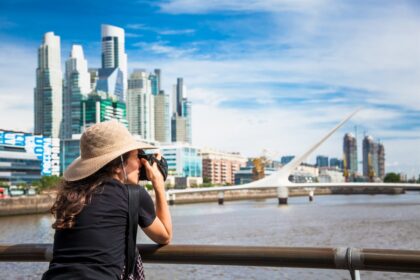 woman takes a photo of the puerto madero district of buenos aires argentina