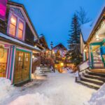 a snowy street in breckenridge colorado with wooden lodges