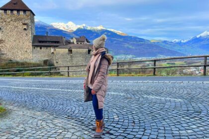 Woman standing in front of castle in Liechtenstein