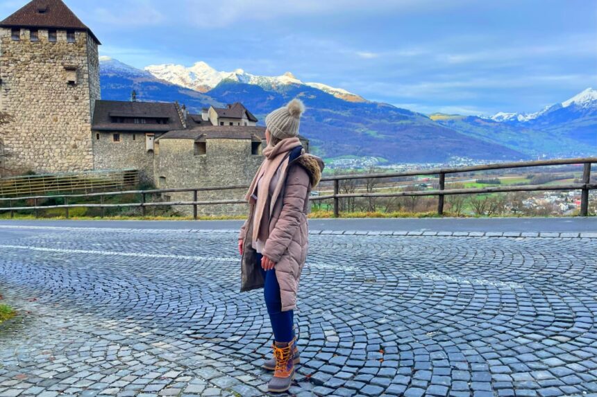 Woman standing in front of castle in Liechtenstein