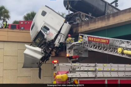 US Firefighters Rescue Driver From Dangling Truck