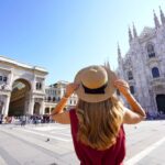 woman holding her hat in Milan, Italy