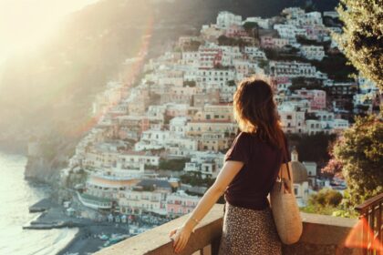 young female traveler admiring view at a lookout point on the amalfi coast in italy