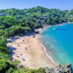 Panoramic aerial view of the beautiful beaches of Sayulita surrounded by greenery on a sunny day