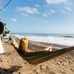 tourist enjoys the sun and sea in a hammock on the Caribbean coast of Colombia
