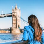 Woman standing in front of Tower Bridge in London