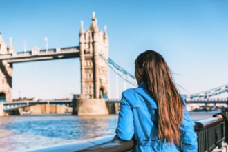 Woman standing in front of Tower Bridge in London