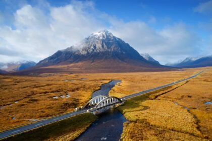 Buachaille Etive Mor mountain in glencoe with a small road bridge in the foreground in scotland