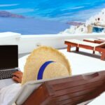 Digital nomad on laptop in Santorini, Greece