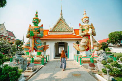 Woman looking at Wat Arun Temple, Bangkok