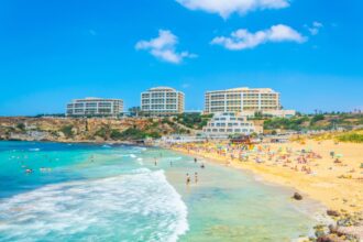 Tourists at Golden Bay Beach in Malta