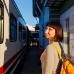 Smiling woman boarding train