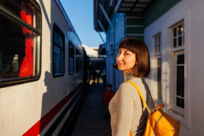 Smiling woman boarding train