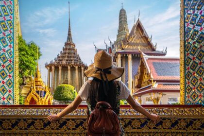 Young Woman Admiring The View Of A Historic Temple In Bangkok, Thailand, Southeast Asia