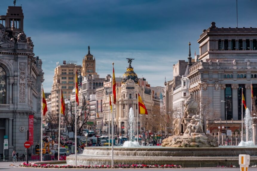 Calle de Alcala, Madrid. Historical buildings, palaces, hotels and the cars in motion.