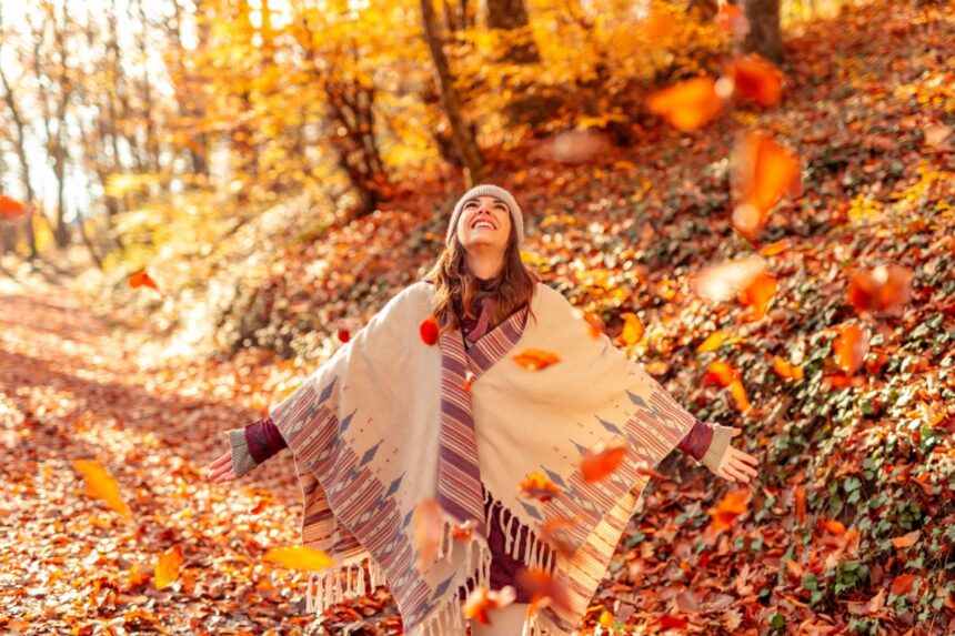 Happy woman in fall foliage