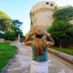 Female tourist visiting Charles V Aragon Castle in Crotone