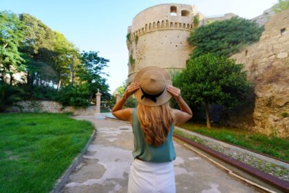 Female tourist visiting Charles V Aragon Castle in Crotone