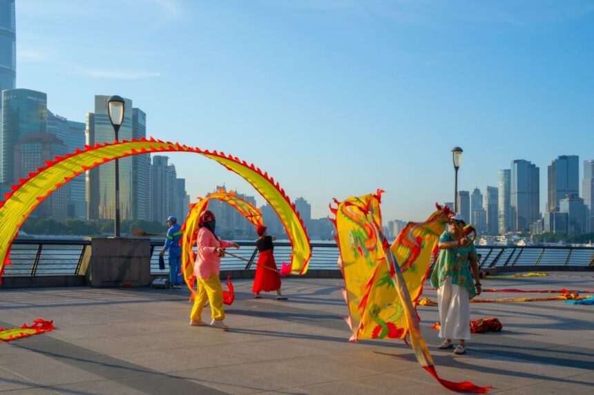 People are practicing ribbon dragon dance in the morning at the Bund in Shanghai, China