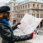 Woman in coat holding map in Vienna