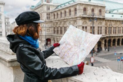 Woman in coat holding map in Vienna