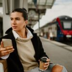 Woman with coffee waiting for train