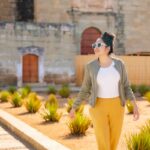 Woman walking by historic Oaxacan building