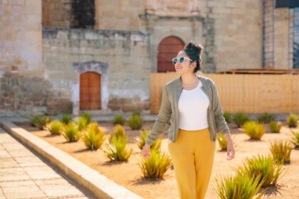 Woman walking by historic Oaxacan building