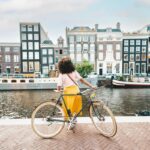 Woman with bicycle in Amsterdam