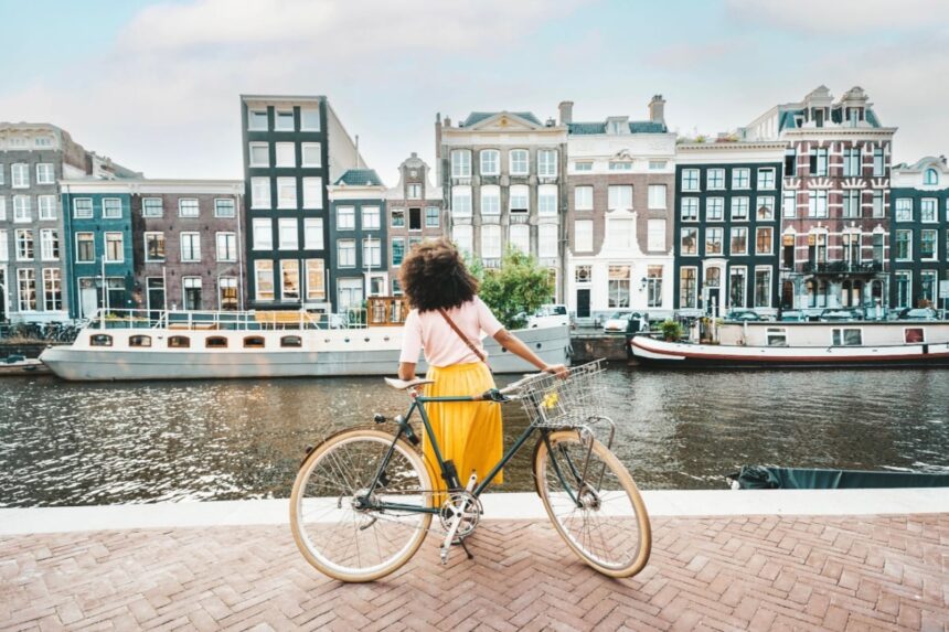 Woman with bicycle in Amsterdam