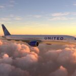 A United Airlines plane over a beautiful sunset