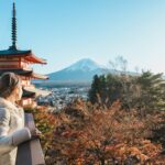 Solo tourist observing sweeping views of Tokyo in fall