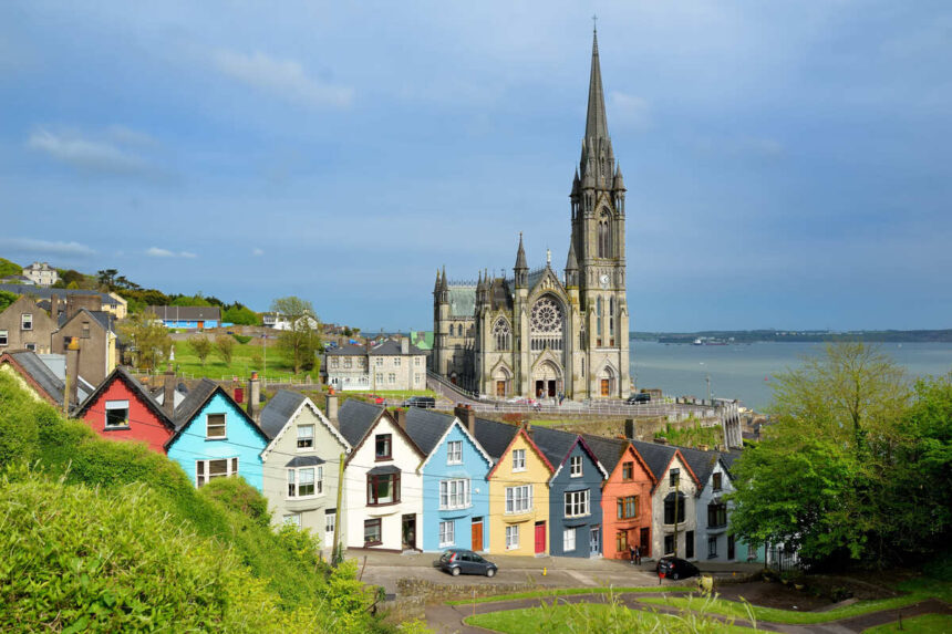 Colorful Row Of Houses With A Cathedral In The Background In Cobh Near Cork, Ireland