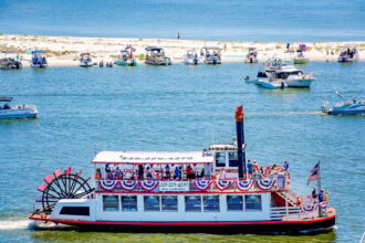 The Betsy Ann riverboat passing white sand beach in Biloxi