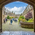 People walking down historic street in Wells, UK