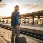 Woman with luggage waiting for train