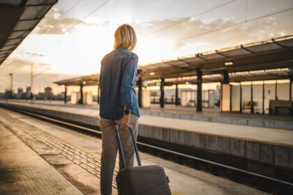 Woman with luggage waiting for train
