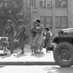 September 25, Military escorts Little Rock Nine into Central High