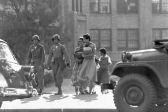 September 25, Military escorts Little Rock Nine into Central High