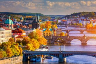 Autumn view to Charles bridge on Vltava river in Prague, Czech Republic. Autumn view to Charles Bridge, Prague old town and Vltava river from popular view point in the Letna park (Letenske sady).