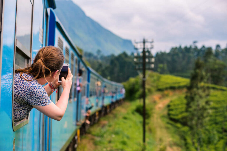 Young Tourist Taking A Picture Of The View On The Train To Ella In Sri Lanka, South Asia