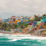 Colorful hillside homes along crashing waves in San Juan, Puerto Rico