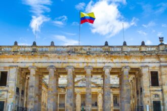 Colombia flag waving over historic building in Bogota