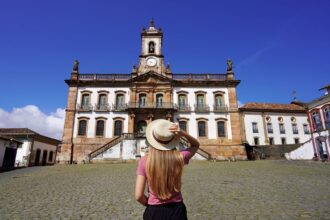 A Young Female Tourist Admiring A Colonial Building In Ouro Preto, Minas Gerais, Brazil