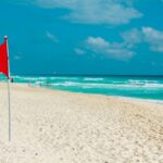 Red flag on a pristine cancun beach