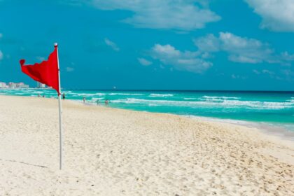 Red flag on a pristine cancun beach