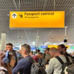 Amsterdam, Netherlands - Passengers waiting in line to clear passport control at Amsterdam Schiphol Airport.
